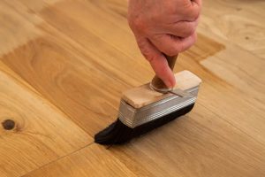 applying a coat of urethane finish