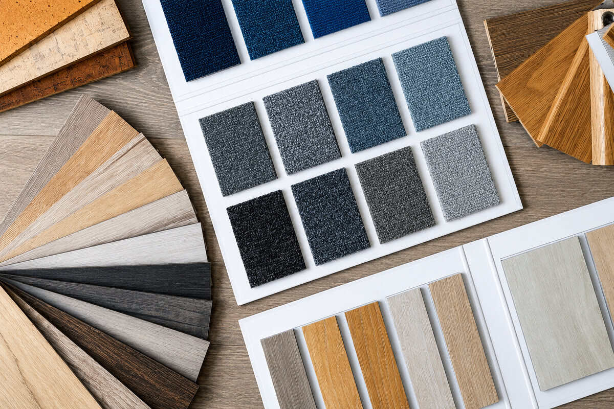 Flooring samples with carpet swatches, wood-look planks, and hardwood colour options for choosing condo flooring materials.